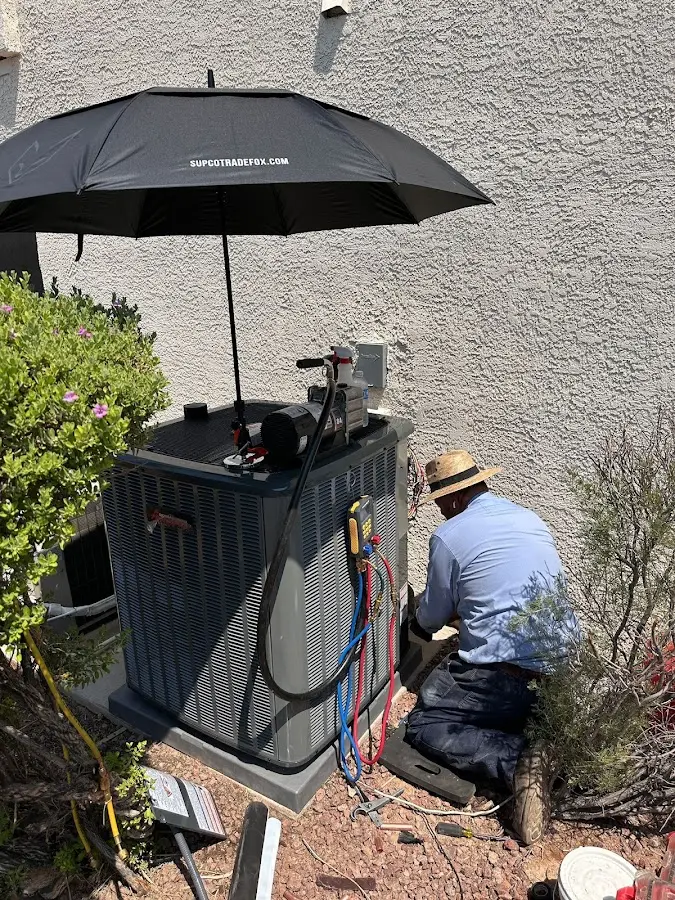 HVAC technician performing outdoor AC maintenance in Sugar Hill