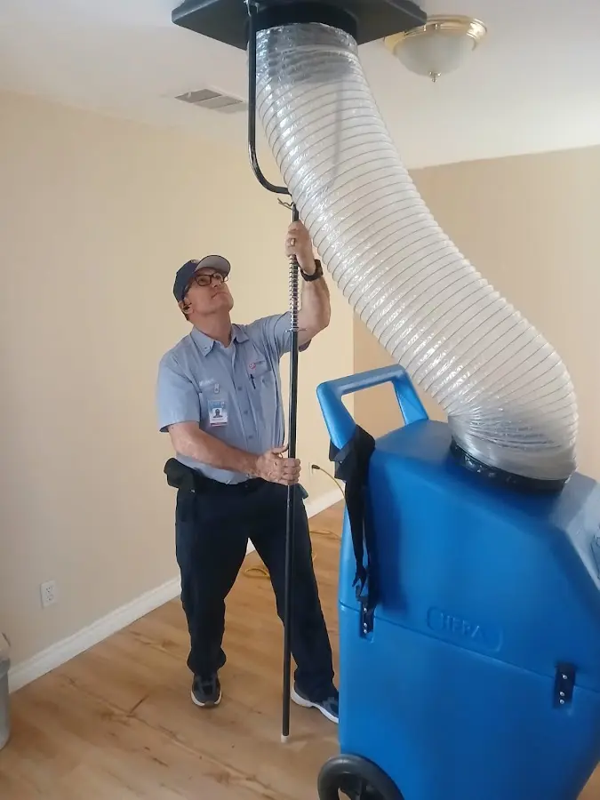 Furnace Tune-Up technician using HEPA equipment in Sugar Hill